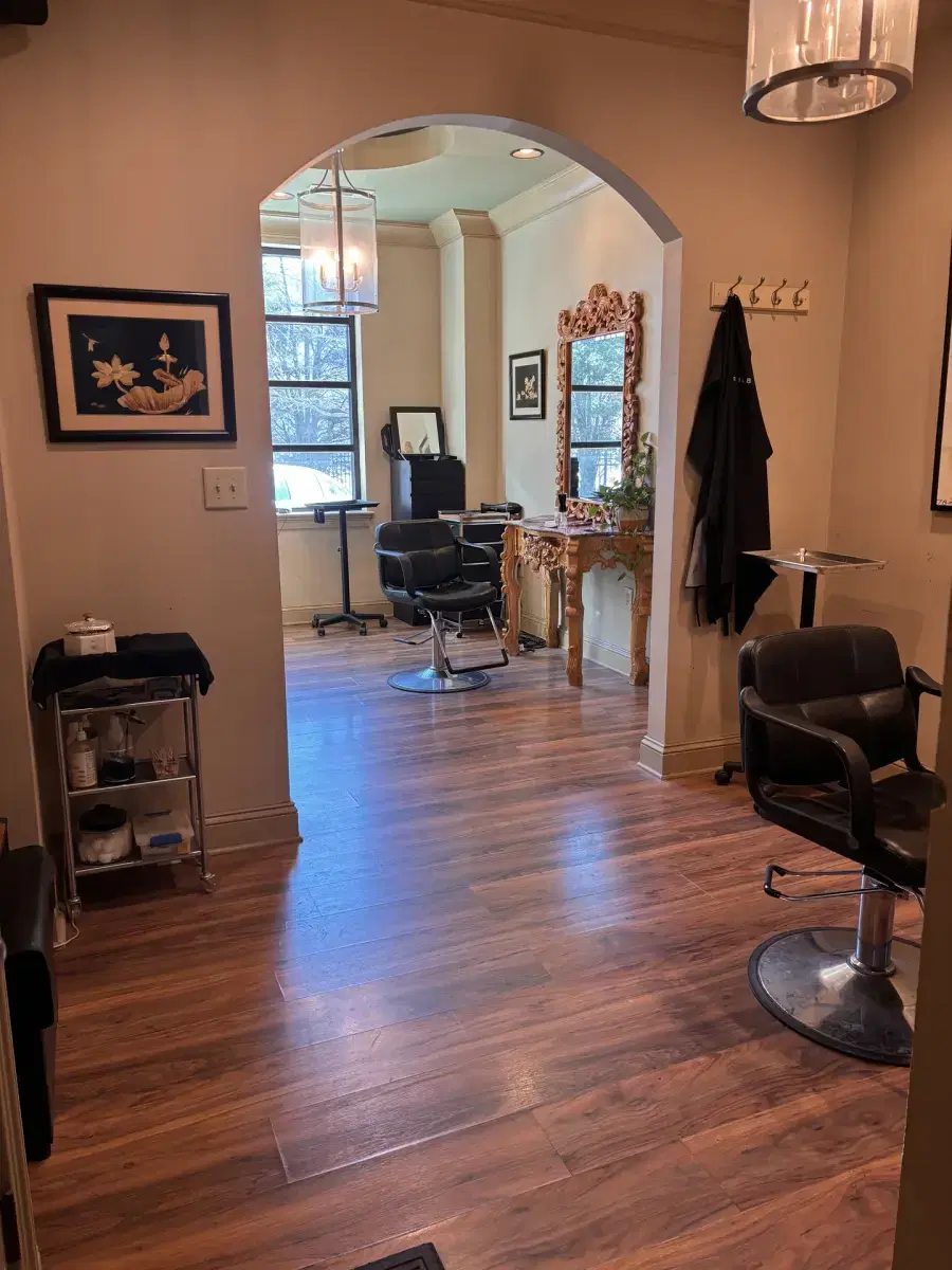 Elegant salon suite interior with large mirror and styling area